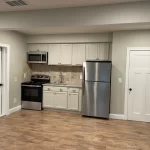 Modern basement rec room with LVP flooring and LED lighting completed by i-Renovate in Canton GA
